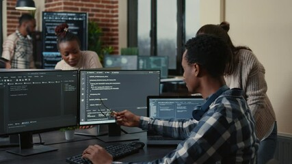 Software developers celebrating successful code compiling doing high five hand gesture with colleague. Programmer analyzing algorithm on multiple screens takes off glasses and congratulates coworker.