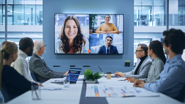Fototapete - Video Conference Call in Office Boardroom Meeting Room: Executive Directors Talk with Group of Multi-Ethnic Entrepreneurs, Managers, Investors. Businesspeople Discuss e-Commerce Investment Strategy