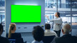 © Gorodenkoff - Modern Product Presentation Event: Black Businesswoman Speaks, Uses Green Chroma Key Screen Wall TV. Press Conference for Group of Diverse Investors, Digital Entrepreneurs, Businesspeople
