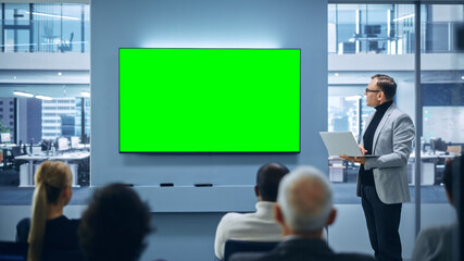 Leinwandbilder - Modern Product Presentation Event: Caucasian Businessman Speaks, Uses Green Chroma Key Screen Wall TV. Press Conference for Group of Diverse Investors, Digital Entrepreneurs