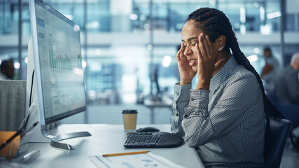 Black Female Corporate Office Worker Feels Stress, Frustration Works on Desktop Computer. Accountant Feeling Project Pressure, Massages Her Head, Works with Statistics, Has Bad Day. Stock Market Crash