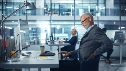 Senior White Male Corporate Office Worker Works on Computer, Feels Sudden Back Pain. Suffering Accountant Feeling Sick Because of all the Work, Stress, Backache