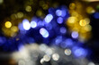 The photo shows blurry blue, yellow silver spots. Concept - abstract festive background