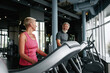 Indoor cardio workout. Elderly man and woman walking on treadmill