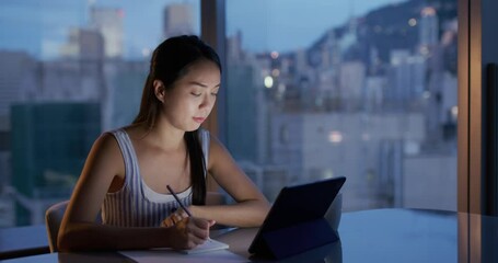 Wall Mural - Woman study on tablet computer in the evening