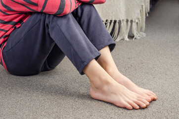girl's bare feet. foot heel. girl sitting on the floor. european