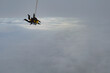 © Sky Antonio - Tandem skydiving. Tandem jump in the cloudy sky.
