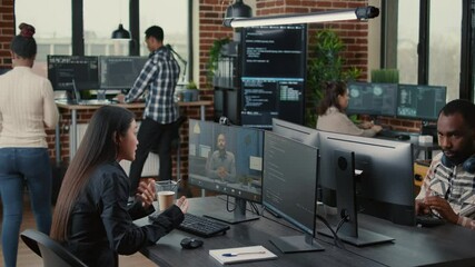 Software company employee in video call conference with business owner discussing coding project deadline in office with team working. Programer having online chat with client about source code.