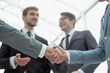 © ASDF - close up. business people, confidently shaking hands.