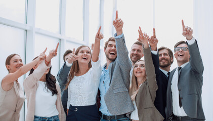 Wall Mural - group of confident young people, pointing somewhere up.