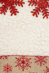 Wall Mural - Red and brown snowflake border winter background on beige sherpa material