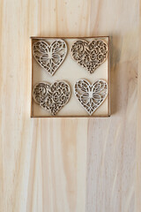 four wooden hearts inside a grungy box 