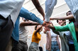 © Daniel - Multiracial coworkers join hands together in a circle.
