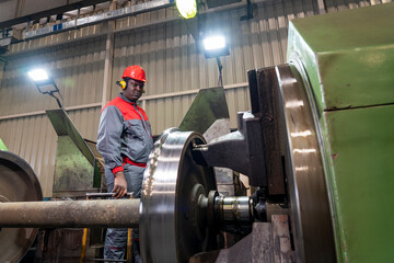 Wall Mural - African Amererican CNC Machine Operator Monitoring The Train Wheel Manufacturing Process On Lathe Machine In A Train Factory