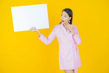 Wall Mural - Portrait beautiful young asian woman with empty white billboard