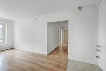 Empty room after repairs in an apartment building. Fresh renovated room with wooden and tiled floors