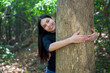 © tonefotografia - young woman hugging a big tree in the woods, environment and conservation concept