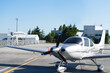 Close up view of Cirrus SR22 aircraft on runway in sunny day.