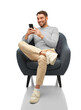 © Syda Productions - people, communication and technology concept - happy smiling man with smartphone sitting in chair over white background
