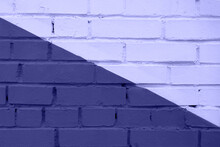 Purple Very Peri Coloured Brick Wall Texture Background. Painted In Half Light And Half Dark Violet Diagonally Empty Wall Closeup. Horizontal Photo. Color Of The Year 2022.