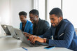 © Alexandr - portrait of successful african men in suits working at the table with laptops