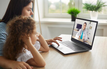 Healthy Mother And Child Enjoying Digital Era, Having Online Telemedicine Consultation With Remote Doctor Or Watching Educational Video By Professional Paediatrician About Cold And Flu Virus Treatment