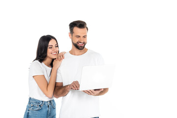 Poster - smiling man using laptop near pretty young woman isolated on white.