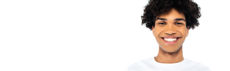 Poster - curly african american man with piercing smiling at camera isolated on white, banner.