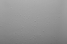 Water Drops On A Grey Plastic Surface
