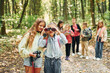 © standret - Conception of tourism. Kids in green forest at summer daytime together