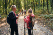 © standret - Founding the way. Kids in green forest at summer daytime together