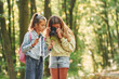 © standret - Two friends. Kids in green forest at summer daytime together