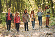 © standret - Group of people. Kids in green forest at summer daytime together