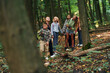 © standret - With touristic equipment. Kids in green forest at summer daytime together