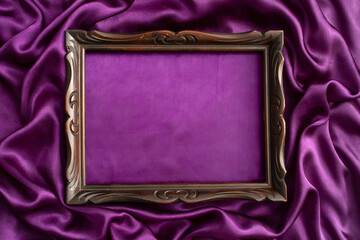 moody mockup photography, of an old sculpted wooden frame, on purple satin background