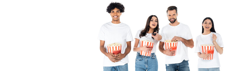 Poster - joyful multiethnic friends eating popcorn while watching movie isolated on white, banner.