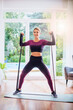 © gzorgz - Fit woman exercising with a power band at home