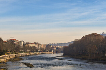 Wall Mural - Scenic view of Lungo Po Luigi Cadorna riverside with Murazzi bank, the river park of Borgo Po district and the Basilica of Superga on the hilltop in winter, Turin, Piedmont, Italy