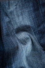 Detail Of Blue Jeans Texture With Folds. Free Room For  Copyspace.