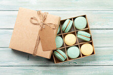 Homemade macaroons in gift box and coffee