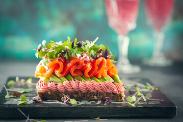 Wall Mural - Gourmet  sandwich  with smoked salmon,avocado, beet hummus and sprouts.