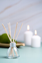 Hygge And Aromatherapy Concept -candles And Aroma Diffuser On Table At Home. High Quality Photo