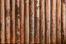 Wooden Logs Wall Stock Photo. Vertical Standing Cabin Wood Wall Pattern. Chestnut Fence Background.