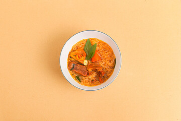 Hu tieu bo kho, Vietnamese Beef Stew with rice noodles, Vietnamese food isolated on beige background, top view