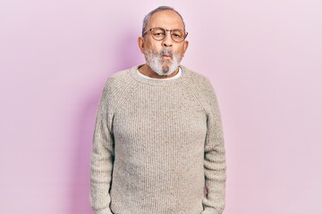 Wall Mural - Handsome senior man with beard wearing casual sweater and glasses making fish face with lips, crazy and comical gesture. funny expression.