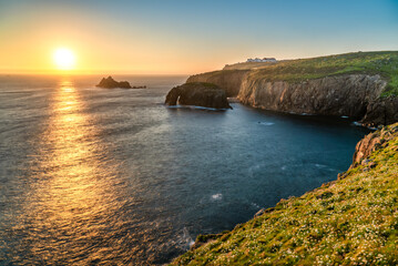 Sticker - Land's End with Enys Dodman arch sunset in Cornwall. United Kiongdom