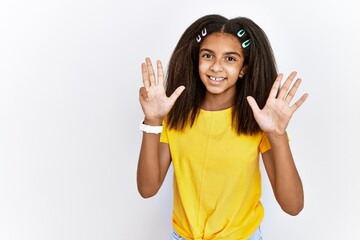 Poster - Young african american girl standing over white isolated background showing and pointing up with fingers number nine while smiling confident and happy.