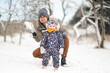 © Justyna - Father and baby girl playing in the snow during wintertime