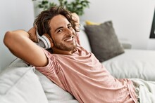 Young Hispanic Man Relaxed With Hands On Head Listening To Music At Home.