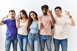 © Krakenimages.com - Group of young people standing together over isolated background shooting and killing oneself pointing hand and fingers to head like gun, suicide gesture.